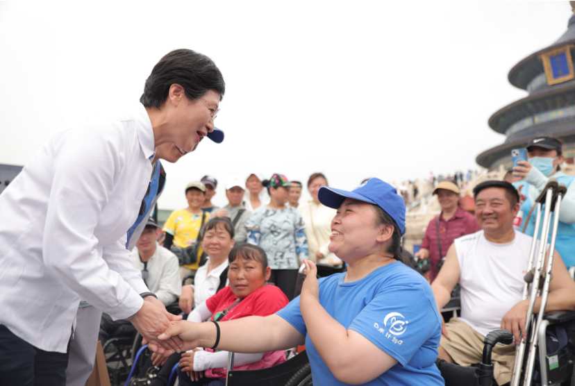 与残疾人员握手交谈